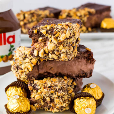 These Nutella Brownie Ice Cream Sandwiches feature Ferrero Rocher stuffed chocolate ice cream sandwiched between two fudgy Nutella brownies. These lovelies are taken to the next level with a chocolate/hazelnut coating! A fun treat for the summertime! 