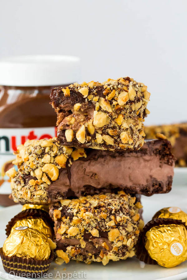 These Nutella Brownie Ice Cream Sandwiches feature Ferrero Rocher stuffed chocolate ice cream sandwiched between two fudgy Nutella brownies. These lovelies are taken to the next level with a chocolate/hazelnut coating! A fun treat for the summertime! 