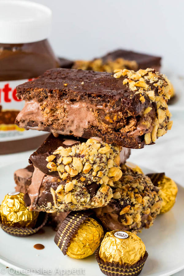 These Nutella Brownie Ice Cream Sandwiches feature Ferrero Rocher stuffed chocolate ice cream sandwiched between two fudgy Nutella brownies. These lovelies are taken to the next level with a chocolate/hazelnut coating! A fun treat for the summertime! 