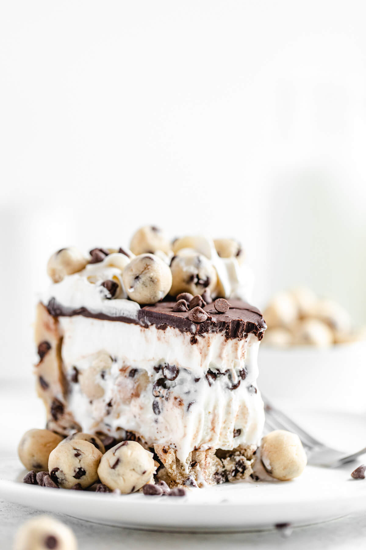 slice of ice cream cake with bite taken out of it on a white plate