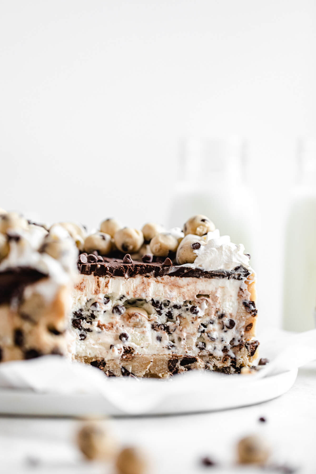 sliced ice cream cake on a parchment covered white plate