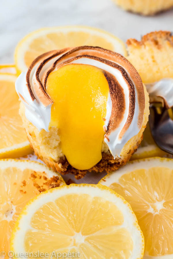 These Mini Lemon Meringue Cheesecakes are incredibly delicious and full of fresh lemon flavour! They’re made with a buttery graham cracker crust, creamy lemon cheesecake filling, and are topped with a ring of toasted meringue with tart lemon curd in the centre. A fun bite-sized treat for summer!