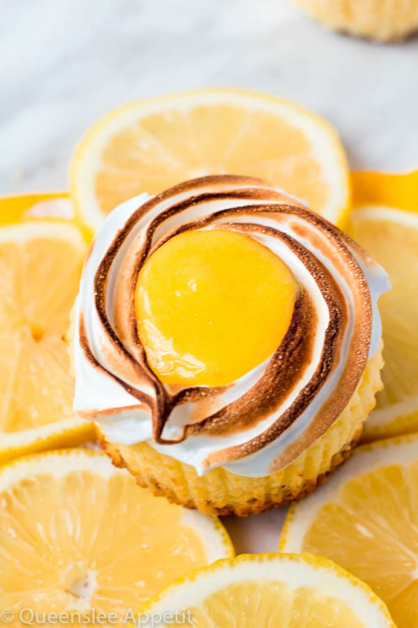 These Mini Lemon Meringue Cheesecakes are incredibly delicious and full of fresh lemon flavour! They’re made with a buttery graham cracker crust, creamy lemon cheesecake filling, and are topped with a ring of toasted meringue with tart lemon curd in the centre. A fun bite-sized treat for summer!