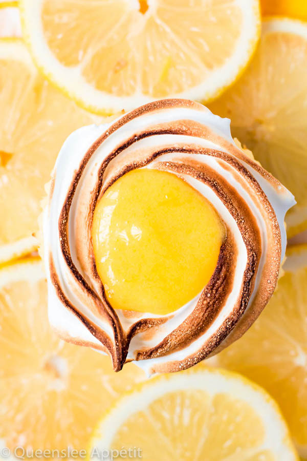 These Mini Lemon Meringue Cheesecakes are incredibly delicious and full of fresh lemon flavour! They’re made with a buttery graham cracker crust, creamy lemon cheesecake filling, and are topped with a ring of toasted meringue with tart lemon curd in the centre. A fun bite-sized treat for summer!