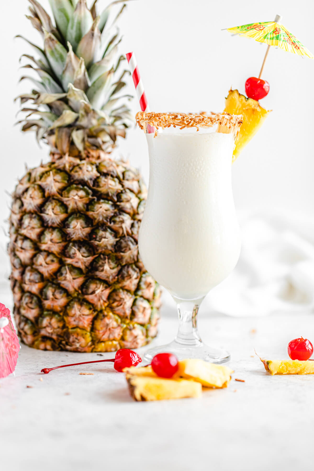 glass of milkshake with pineapple in the background