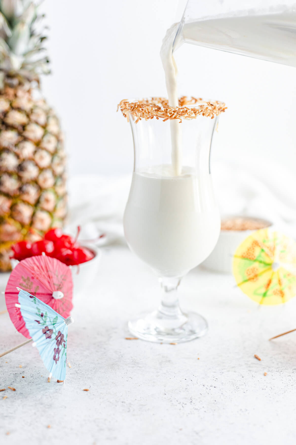 pouring milkshake into glass