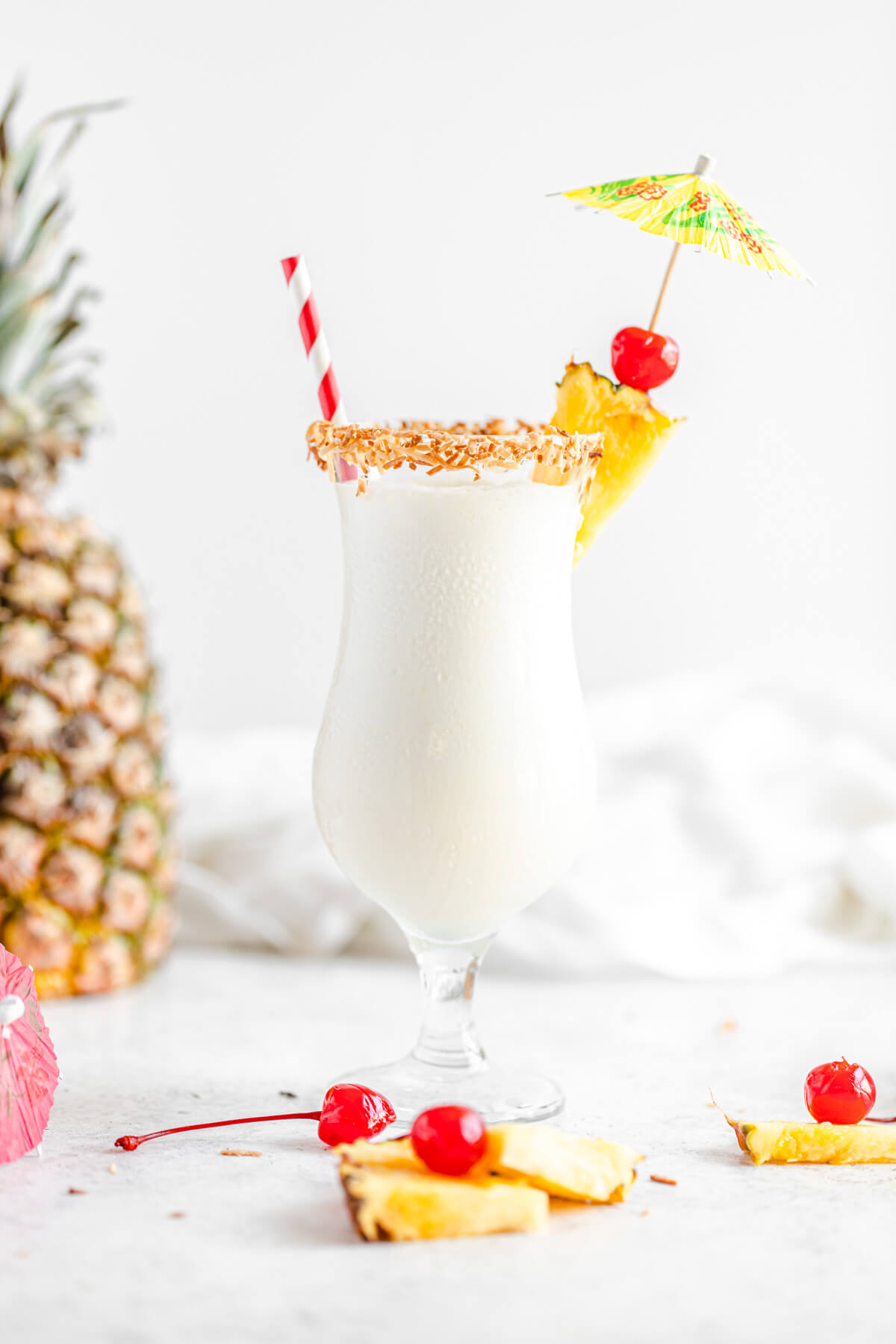 milkshake with pineapple chunks and cherries around it