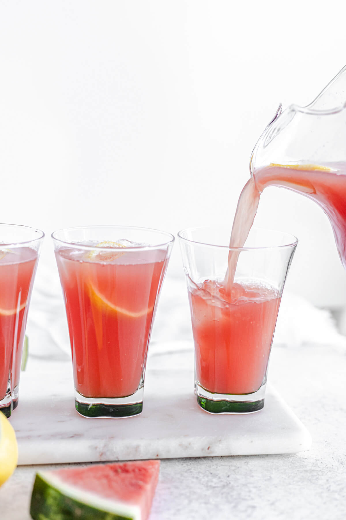 pouring lemonade into glass