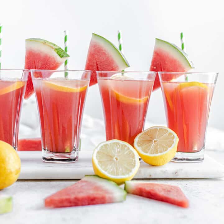 four glasses of lemonade on a marble board