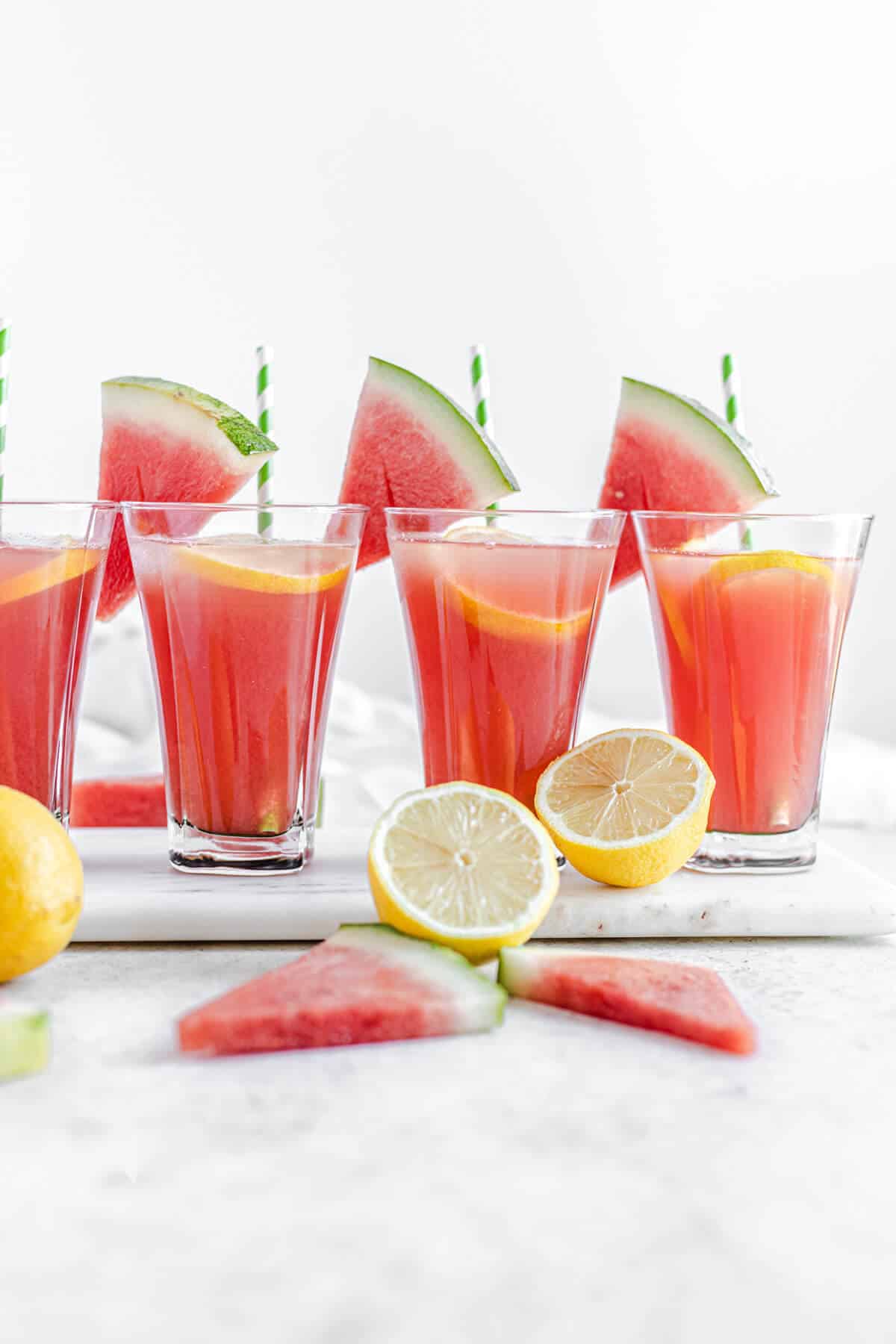 four glasses of lemonade on a marble board