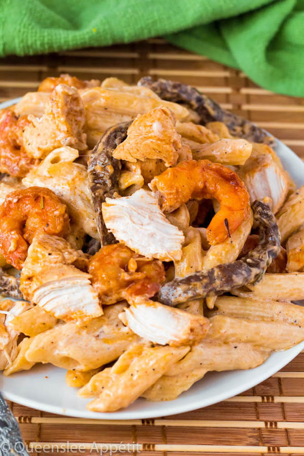 This Cajun Shrimp Chicken and Steak Alfredo Pasta is made with penne pasta, cajun flavoured shrimp, chicken and steak all coated in a creamy Alfredo sauce. An easy weekday dinner jam-packed with loads of flavour in every bite! 