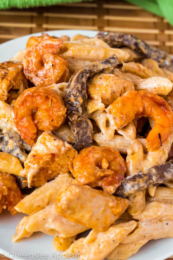 This Cajun Shrimp Chicken and Steak Alfredo Pasta is made with penne pasta, cajun flavoured shrimp, chicken and steak all coated in a creamy Alfredo sauce. An easy weekday dinner jam-packed with loads of flavour in every bite! 