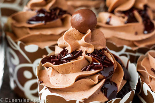 Malted Belgian Chocolate Cupcakes featuring moist malt chocolate cupcakes with a malted milk chocolate Belgian buttercream frosting and a surprise toasted marshmallow filling. Top these cupcakes off with a rich chocolate ganache, chocolate sprinkles and a malteeser candy for a fun summer treat! 