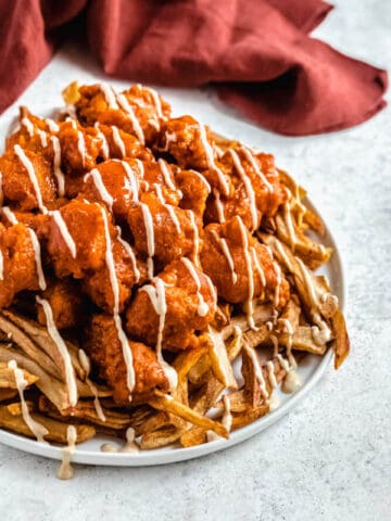 large plate of buffalo chicken nuggets and fries