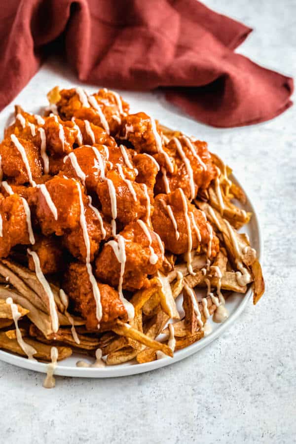 large plate of buffalo chicken nuggets and fries