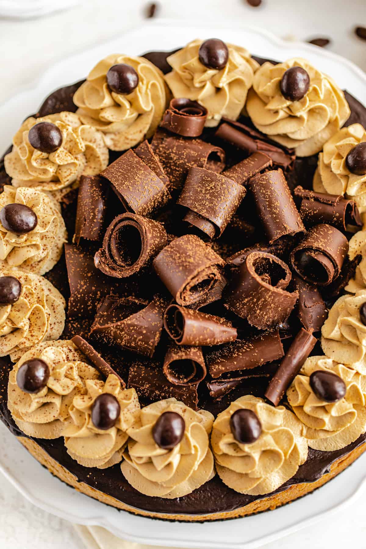 close up top shot of chocolate curls on cheesecake