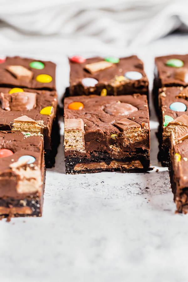 brownies topped with fudge and stuffed with halloween candy