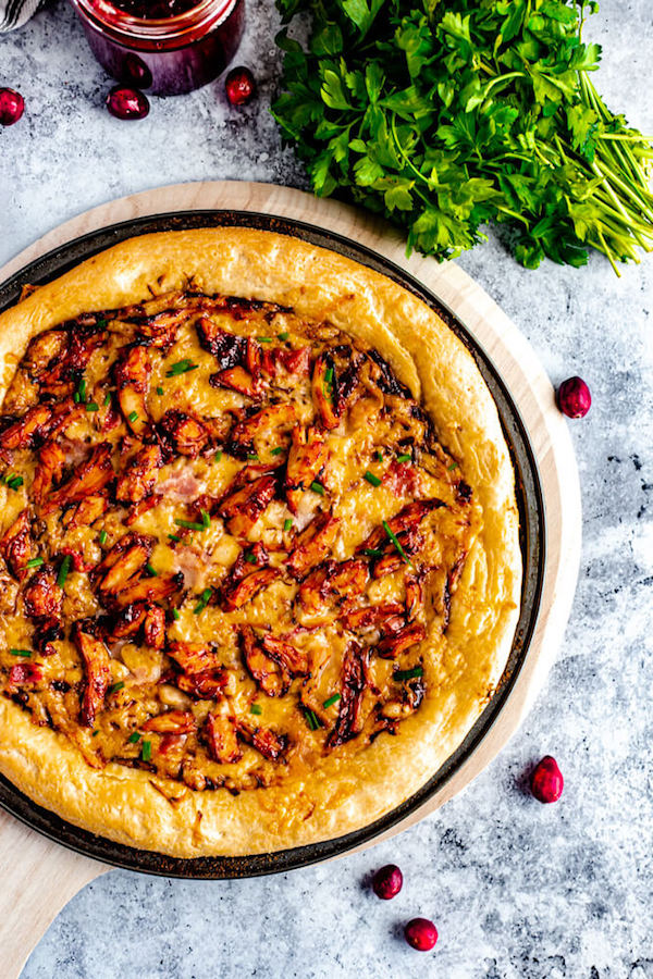 whole pizza on a pizza pan and pizza stone