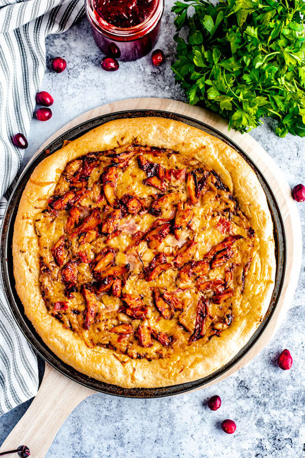 cranberry bbq turkey pizza on a pizza stone