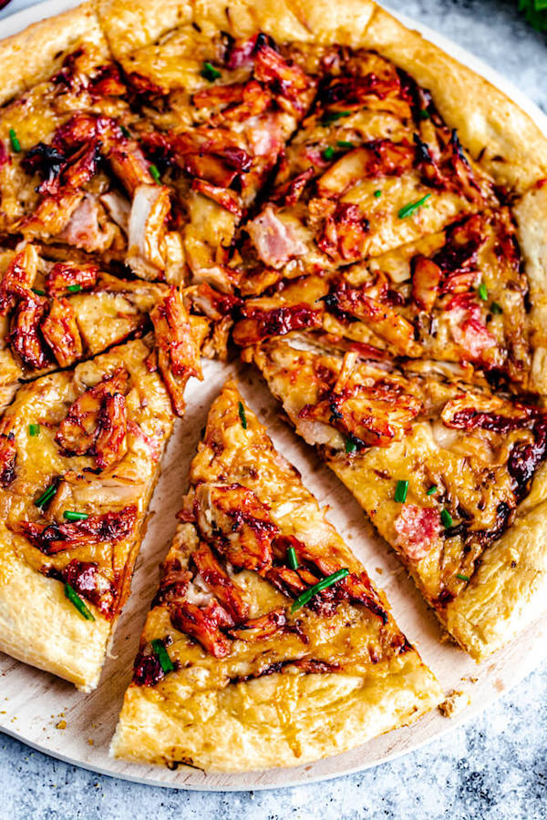 slices of cranberry bbq turkey pizza on a pizza stone