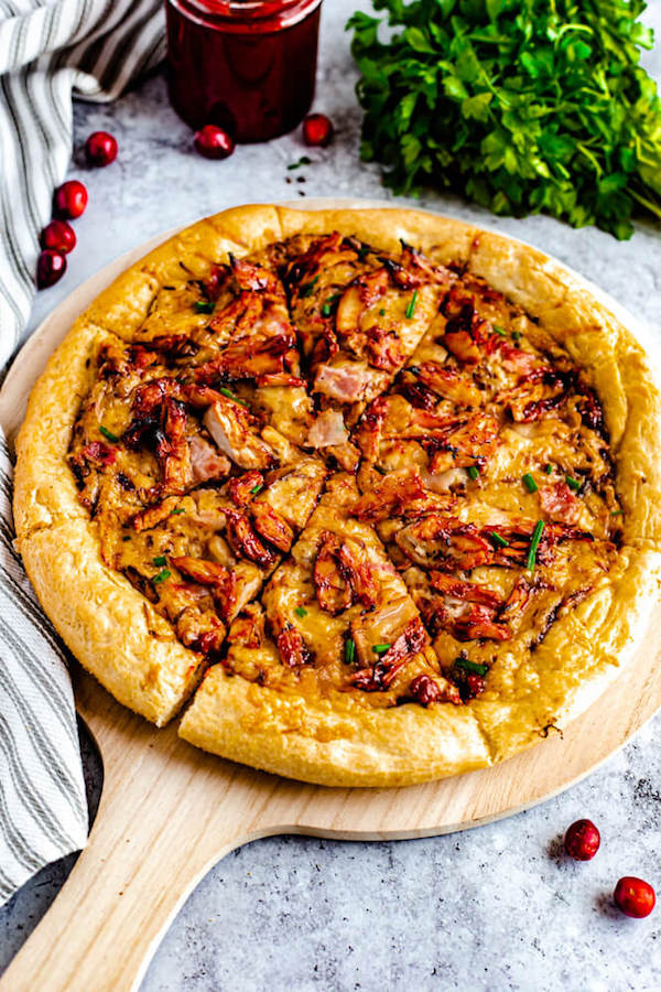 cranberry bbq turkey pizza on a pizza stone