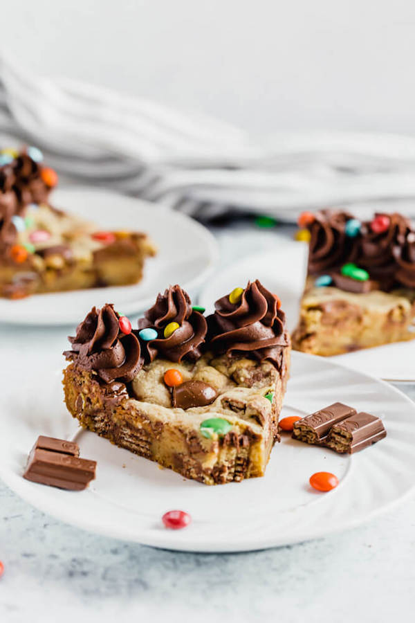 cookie cake loaded with halloween candy and topped with chocolate buttercream