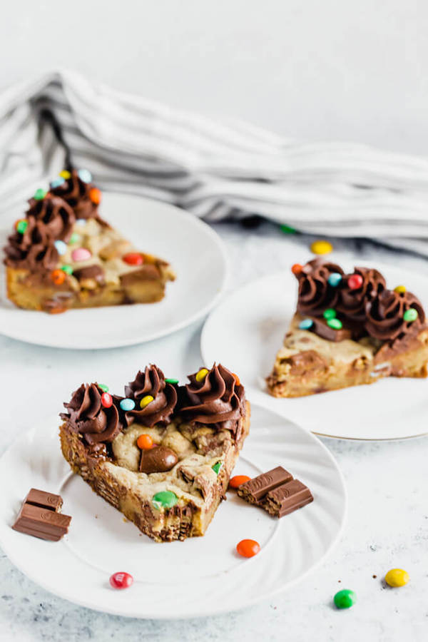 cookie cake loaded with halloween candy and topped with chocolate buttercream