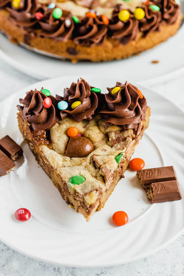 cookie cake loaded with halloween candy and topped with chocolate buttercream