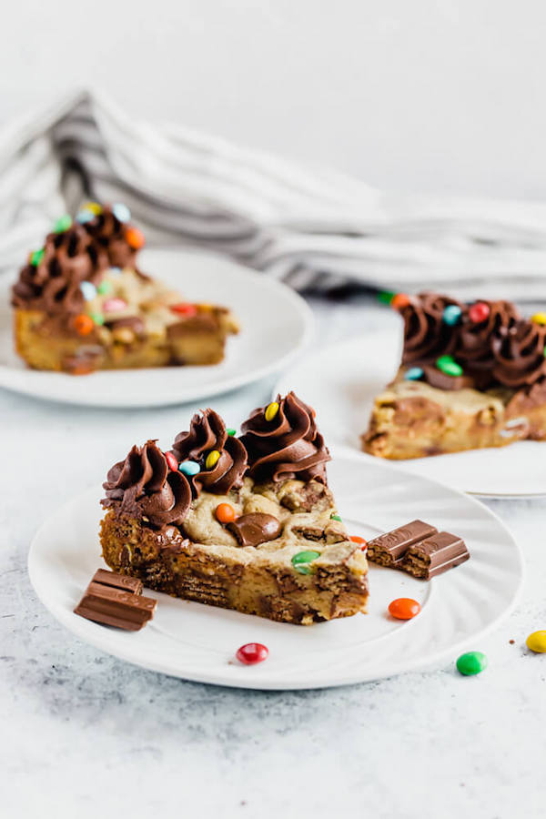 cookie cake loaded with halloween candy and topped with chocolate buttercream