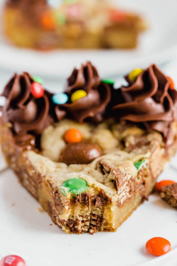 cookie cake loaded with halloween candy and topped with chocolate buttercream