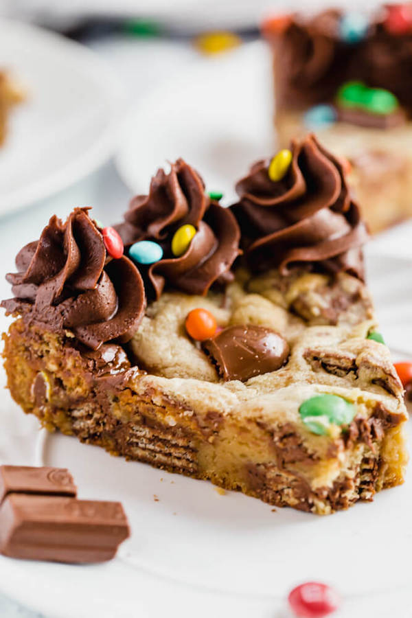 cookie cake loaded with halloween candy and topped with chocolate buttercream