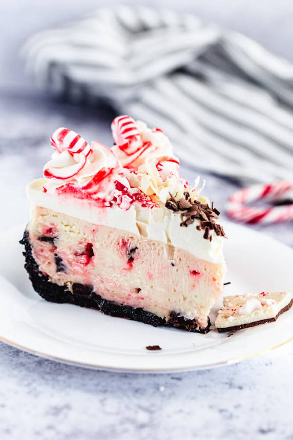 chocolate candy cane cheesecake on a white plate