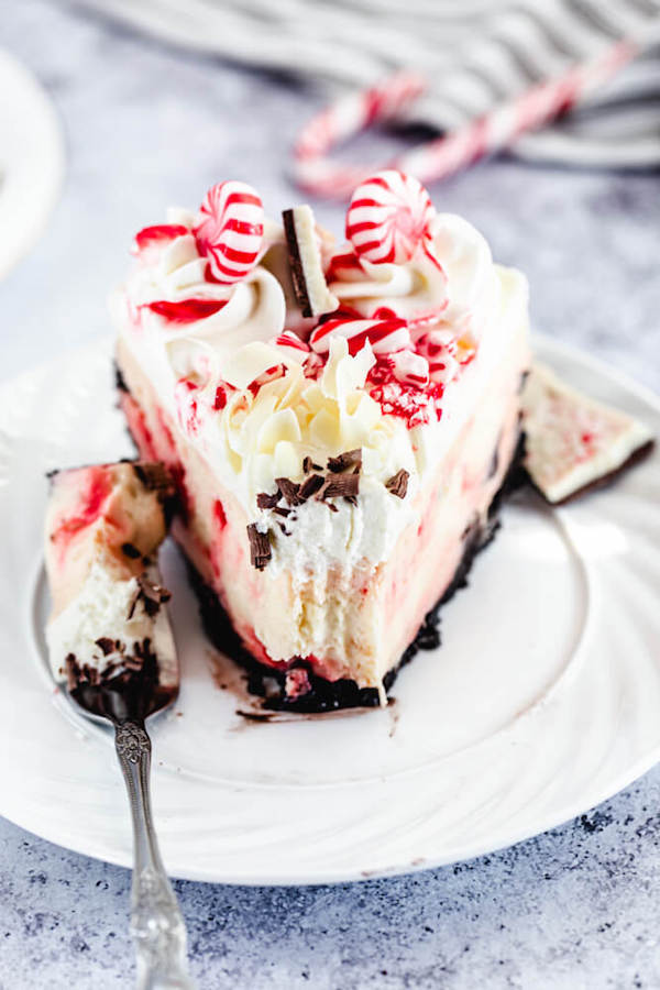 white chocolate cheesecake on a white plate with bite taken out