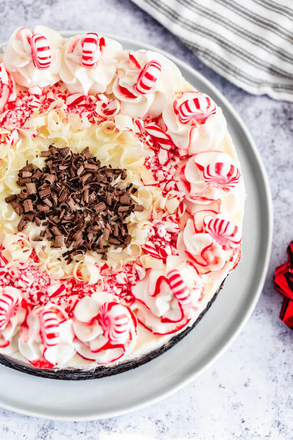 top view of full peppermint bark cheesecake on a cake stand
