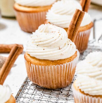 cupcakes on a safety grater with cinnamon sticks on top of them