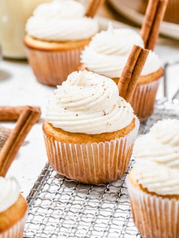 cupcakes on a safety grater with cinnamon sticks on top of them