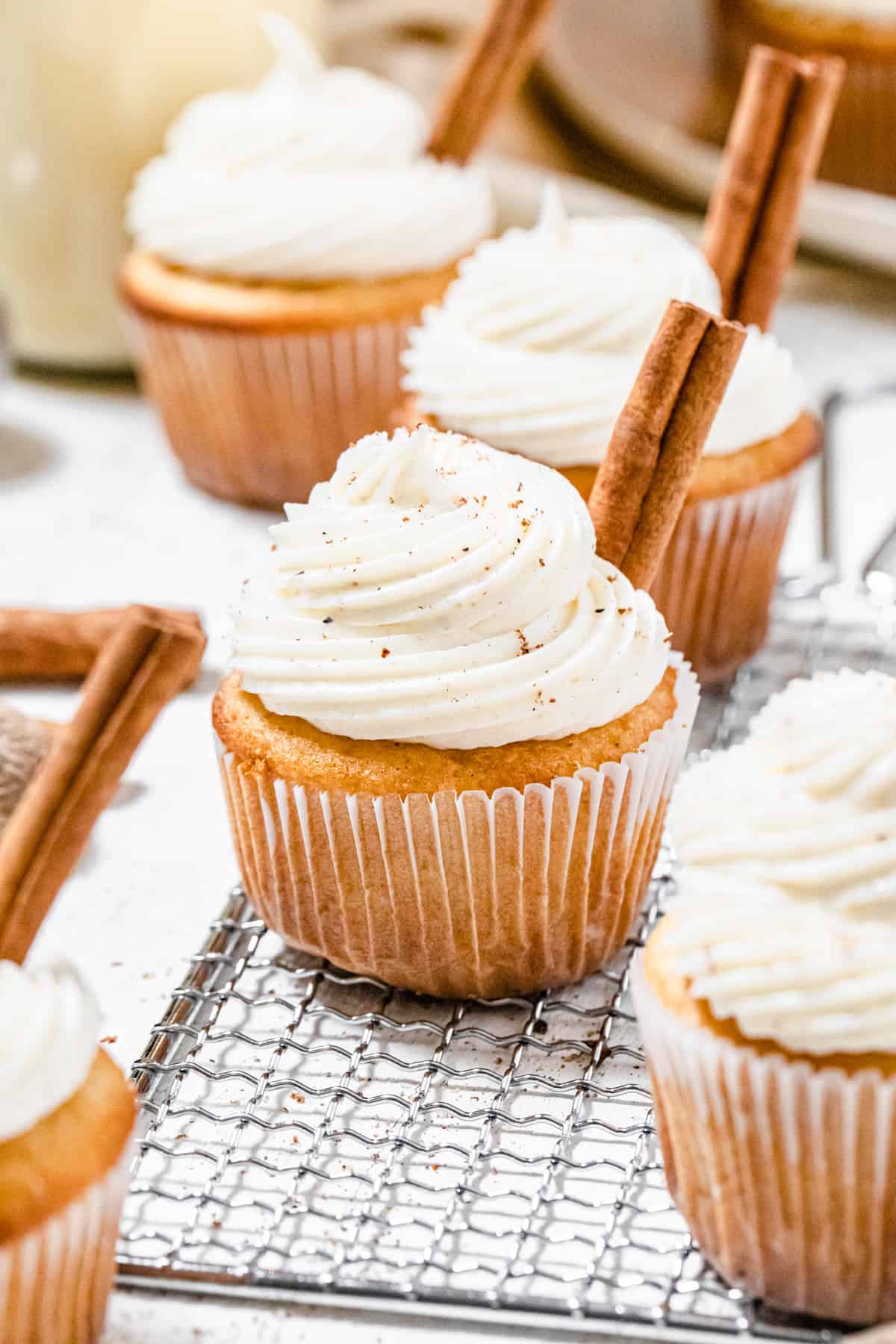 cupcakes on a safety grater with cinnamon sticks on top of them