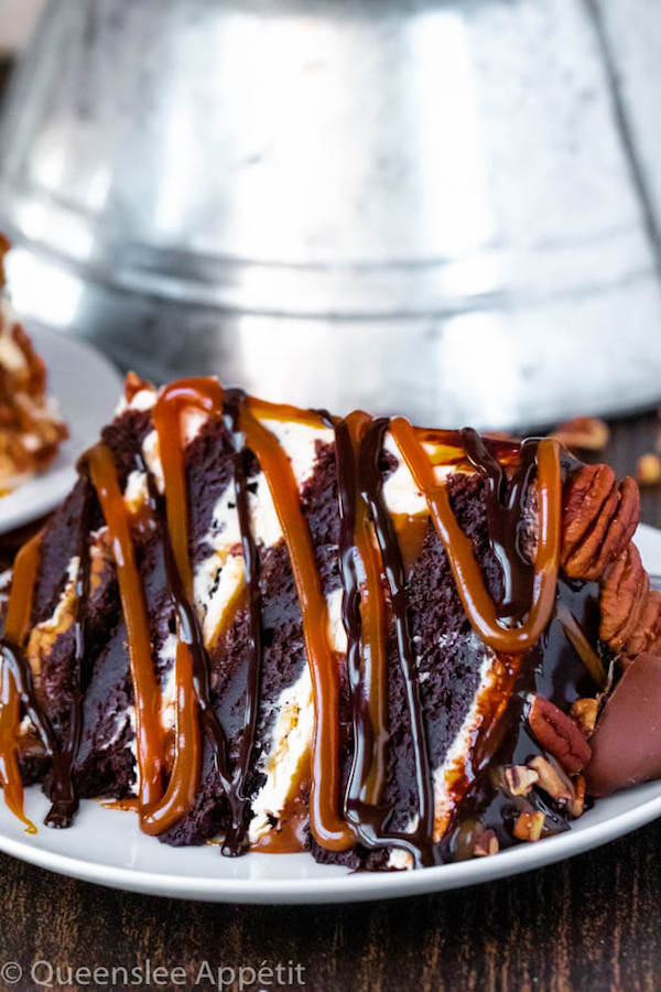 This Turtle Chocolate Layer Cake starts with rich, decadent and moist chocolate cake layers that are filled with a caramel pecan sauce and covered in a smooth caramel frosting, then finished off with a caramel and ganache drip and chopped pecans! 