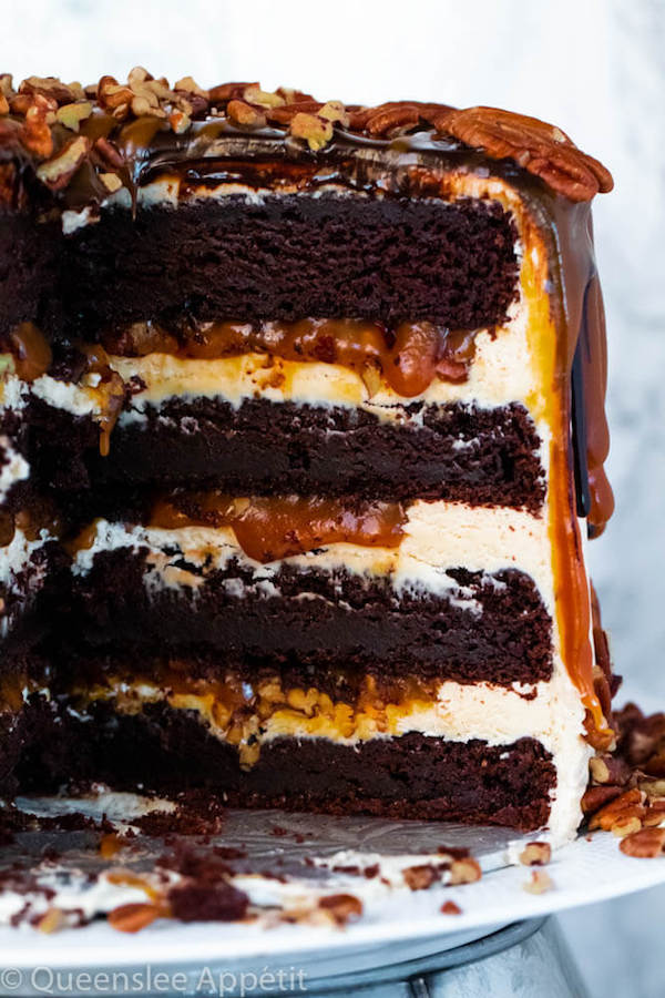 This Turtle Chocolate Layer Cake starts with rich, decadent and moist chocolate cake layers that are filled with a caramel pecan sauce and covered in a smooth caramel frosting, then finished off with a caramel and ganache drip and chopped pecans! 