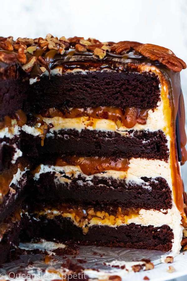 This Turtle Chocolate Layer Cake starts with rich, decadent and moist chocolate cake layers that are filled with a caramel pecan sauce and covered in a smooth caramel frosting, then finished off with a caramel and ganache drip and chopped pecans! 