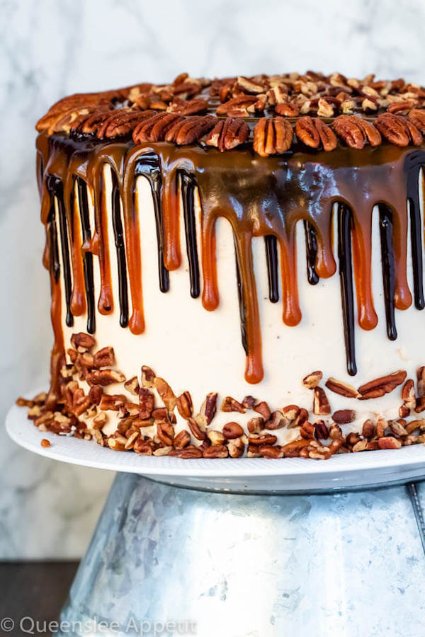 This Turtle Chocolate Layer Cake starts with rich, decadent and moist chocolate cake layers that are filled with a caramel pecan sauce and covered in a smooth caramel frosting, then finished off with a caramel and ganache drip and chopped pecans! 