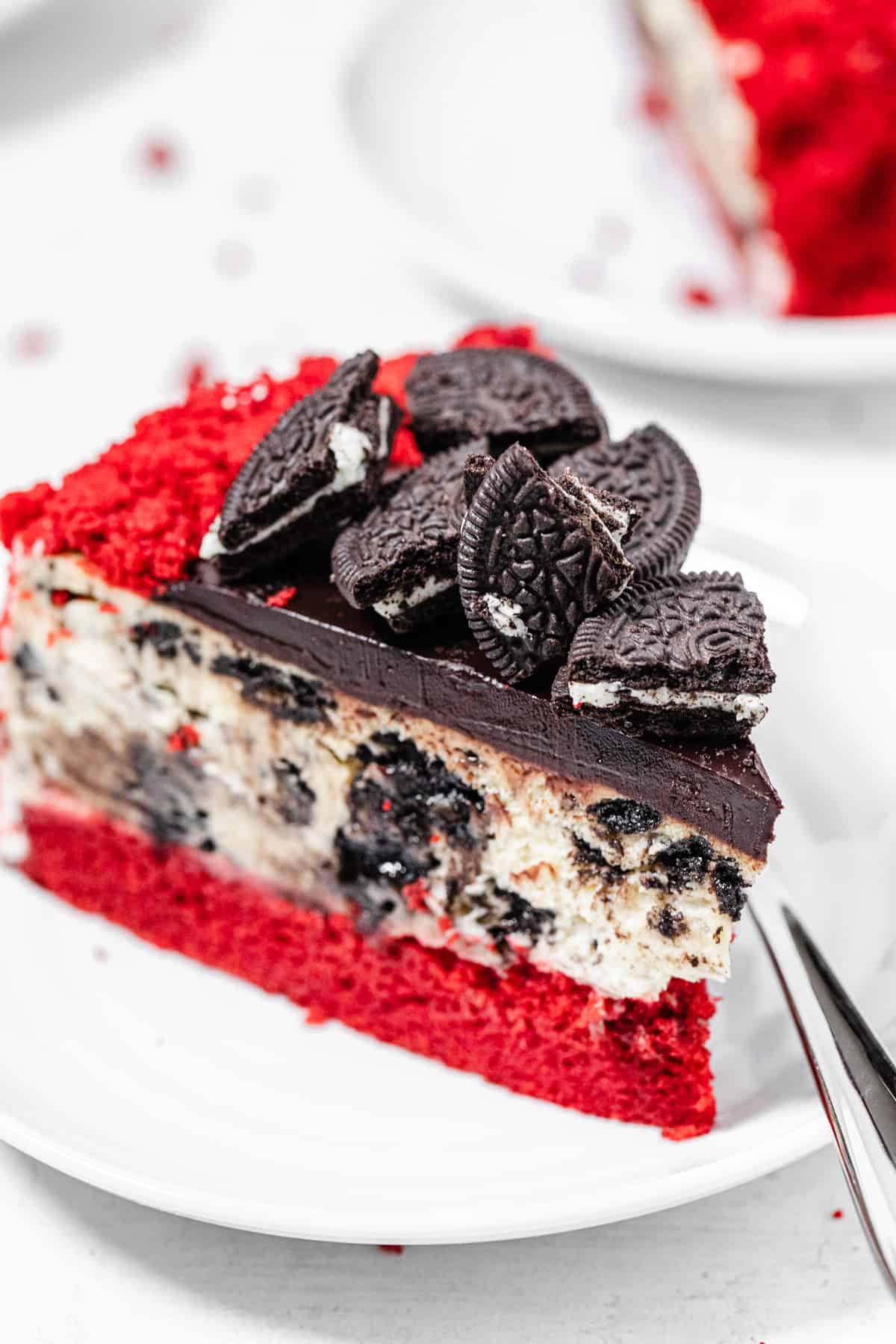 close up of a slice of cheesecake on a small white plate