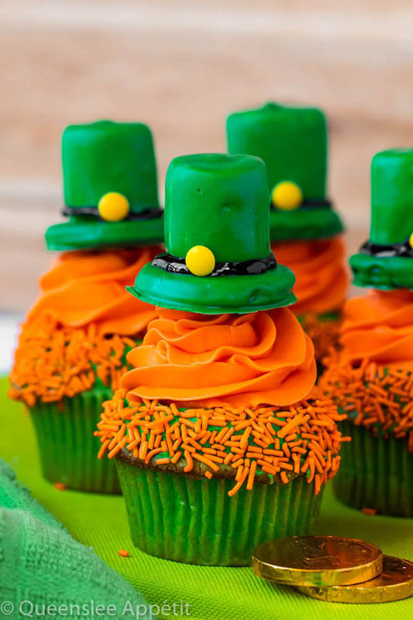These Leprechaun Hat Cupcakes are super adorable and fun to make! A moist green vanilla cupcake stuffed with gold sprinkles, topped with a fluffy green and orange vanilla frosting and a cute little leprechaun hat sitting on top! This is the ultimate St. Patrick’s Day treat!