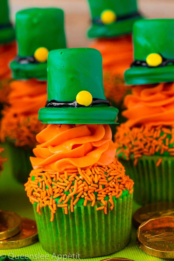 These Leprechaun Hat Cupcakes are super adorable and fun to make! A moist green vanilla cupcake stuffed with gold sprinkles, topped with a fluffy green and orange vanilla frosting and a cute little leprechaun hat sitting on top! This is the ultimate St. Patrick’s Day treat!