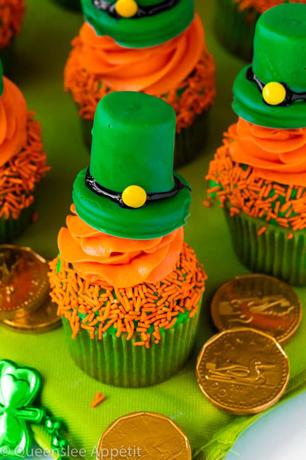 These Leprechaun Hat Cupcakes are super adorable and fun to make! A moist green vanilla cupcake stuffed with gold sprinkles, topped with a fluffy green and orange vanilla frosting and a cute little leprechaun hat sitting on top! This is the ultimate St. Patrick’s Day treat!