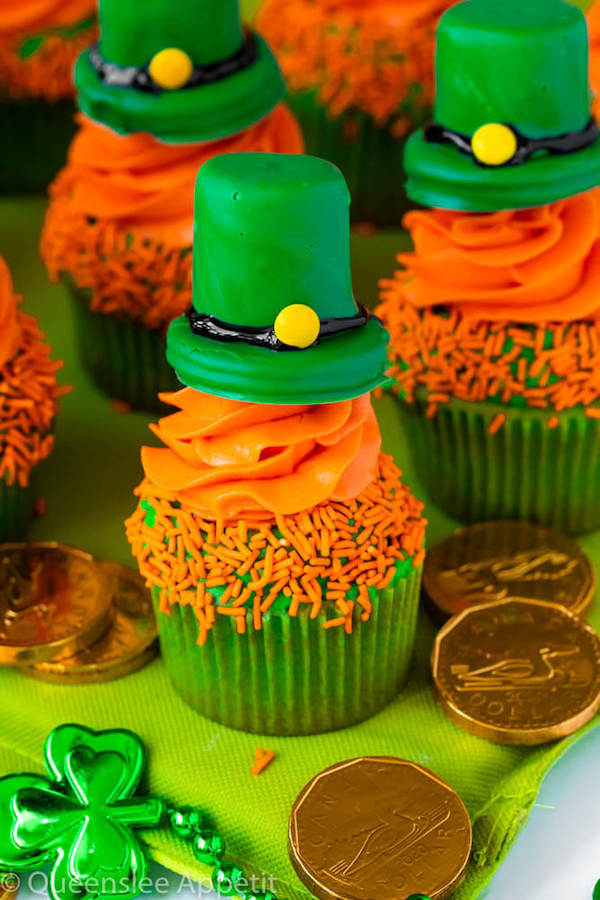 These Leprechaun Hat Cupcakes are super adorable and fun to make! A moist green vanilla cupcake stuffed with gold sprinkles, topped with a fluffy green and orange vanilla frosting and a cute little leprechaun hat sitting on top! This is the ultimate St. Patrick’s Day treat!