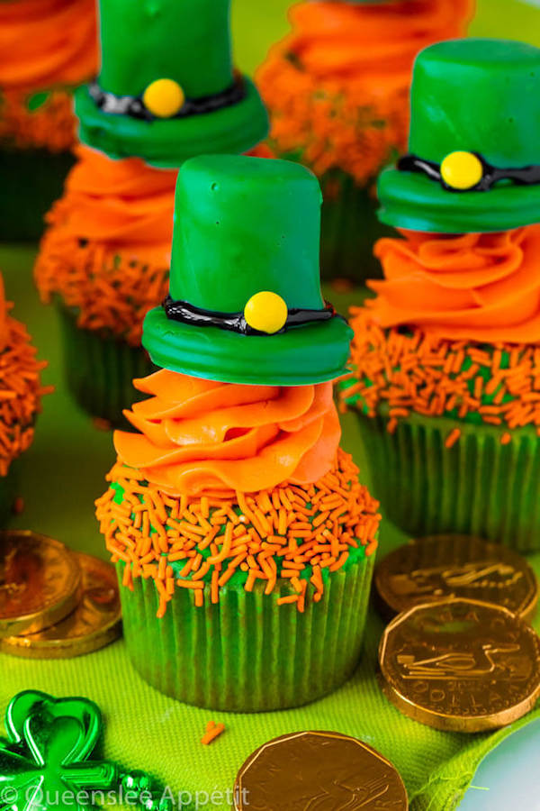 These Leprechaun Hat Cupcakes are super adorable and fun to make! A moist green vanilla cupcake stuffed with gold sprinkles, topped with a fluffy green and orange vanilla frosting and a cute little leprechaun hat sitting on top! This is the ultimate St. Patrick’s Day treat!