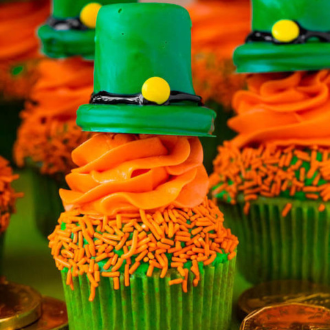 These Leprechaun Hat Cupcakes are super adorable and fun to make! A moist green vanilla cupcake stuffed with gold sprinkles, topped with a fluffy green and orange vanilla frosting and a cute little leprechaun hat sitting on top! This is the ultimate St. Patrick’s Day treat!