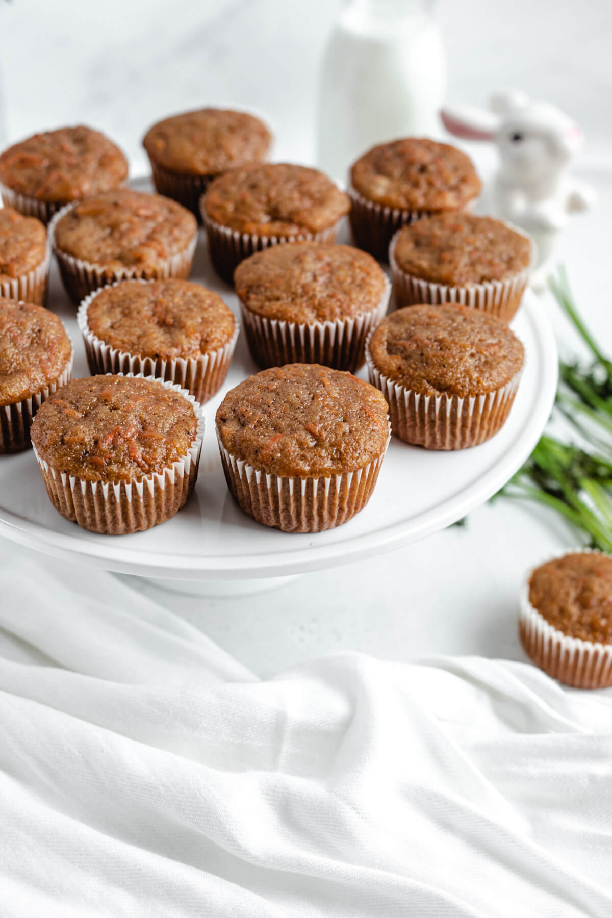 unfrosted cupcakes on a white cake stand