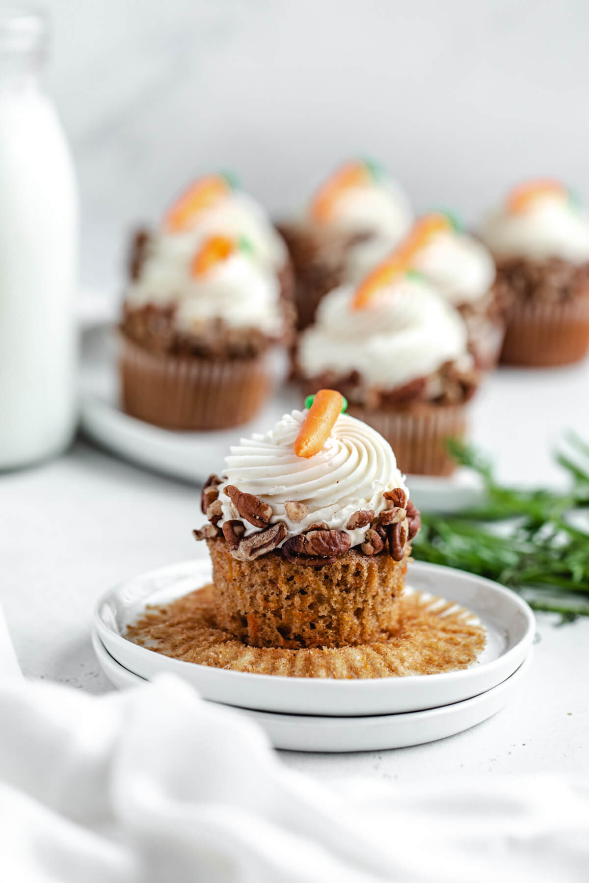 unwrapped cupcake on a stack of small white plates